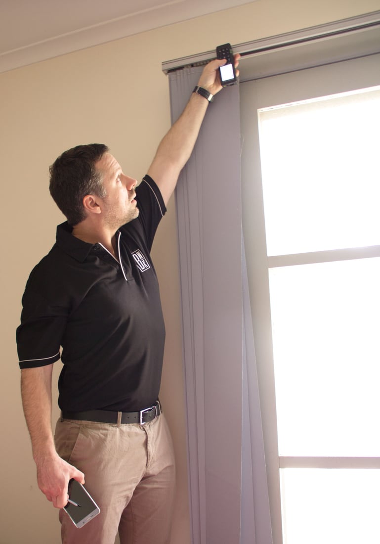 Black-and-white BWK Group quantity surveyor inspecting internal building elements for a property report
