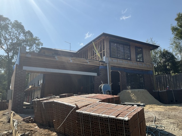 Progress claim report photo showing brickwork and framing stage for construction funding drawdown review.