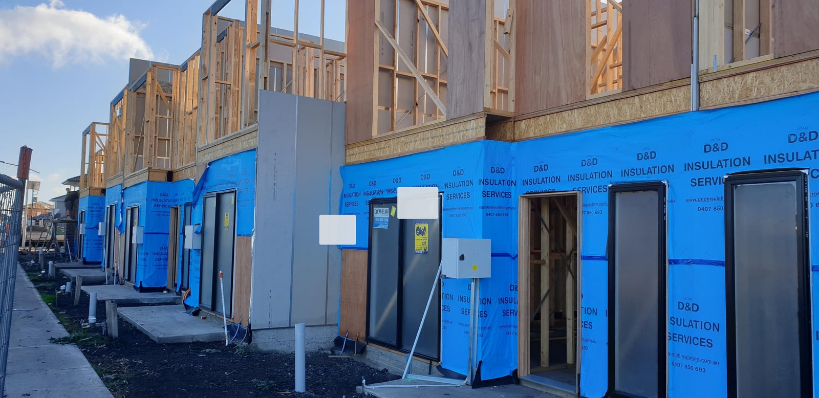 Black-and-white townhouse construction image used to represent tax depreciation schedule reporting.